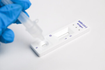 Man makes a covid-19 antigen pcr test macro. The test showed a positive result.