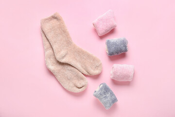 Different warm socks on pink background