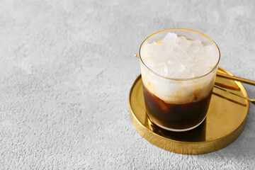 Glass of White Russian cocktail on light background