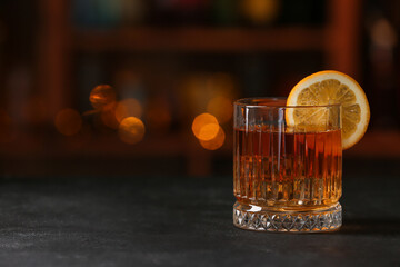 Glass of tasty Old Fashioned Cocktail on table in bar