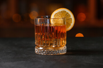 Glass of tasty Old Fashioned Cocktail on table in bar