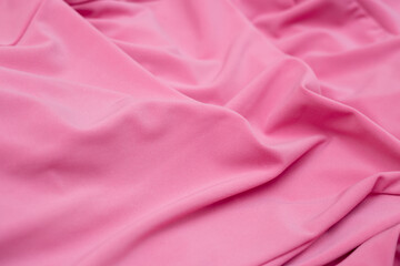 Soft focus texture of the silk fabric, soft pink. Peach pink fabric background.  Crumpled soft rose color satin texture   Pastel textile background.
