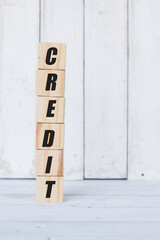 wooden cube, with the word credit, with white wooden background