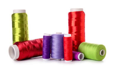 Different sewing thread spools on white background