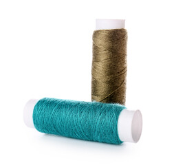 Different sewing thread spools on white background
