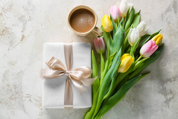 Obraz na płótnie Canvas Beautiful tulip flowers, cup of coffee and gift box for International Women's Day on light background