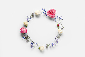 Circle made of beautiful flowers on light background