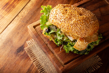 Healthy homemade sandwich with grilled chiken breast, lettuce, avocado, alfalfa germ and various...