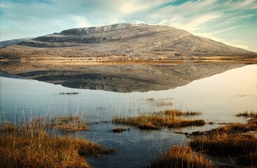 Beautiful morning landscape scenery with mountains reflected in Lake at Burren National Park in...