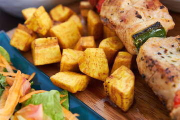 chickens skewers with fried plantains and salad