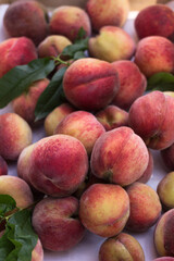 Lots of ripe peaches in a wooden box. Fruit background, healthy food