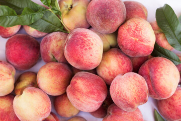Lots of ripe peaches in a wooden box. Fruit background, healthy food
