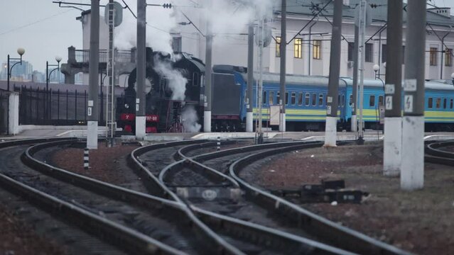 Vintage black steam locomotive. Historic train. Vehicle locomotive departs
