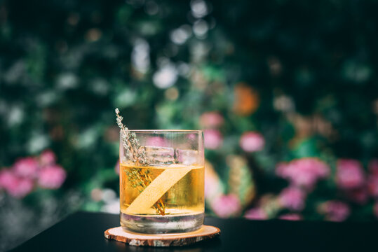 White negroni cocktail outside, in the teal color natural background