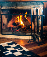 Fireplace burning in the mountain hut on a winter day