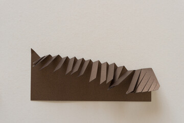 bronze paper object with fringe