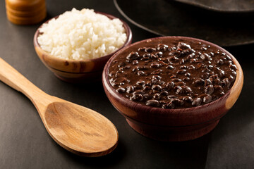 Black beans and rice in wooden bowl.