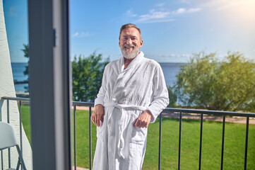 Pleased vacationer posing for the camera against a picturesque landscape