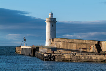 BUCKIE,MORAY, SCOTLAND - 23 JANUARY 2022: This is the sun shining on the entrance to the harbour at...