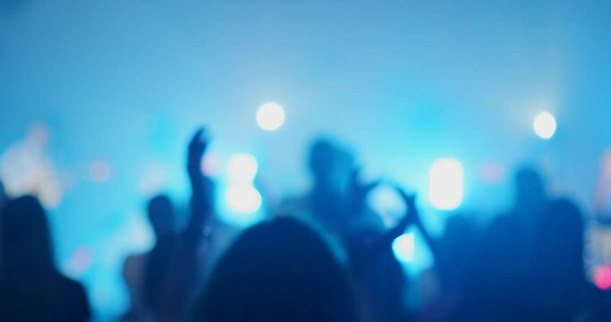 Rock or Pop Band Concert with Crowds of Dancing, Jumping and Applauding People. Live Music Festival or Night Event with Light Show Performance. Blurred 4K handheld shot in slow motion