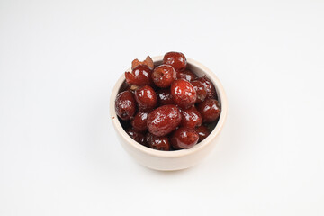 Chinese red date or Jujube asian herbal fruit for healthy on white background under sunlight. The fruit and its seeds are used in Chinese traditional medicine.