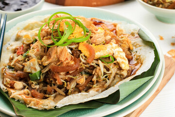 Lumpia Basah Bandung, Popular Traditional Street Food Snack Made from Thin Wrapper with Saute Spicy Soy Bean Sprout and Bamboo Sprout, add with Sticky Sweet Paste from Starch