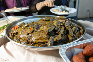A view a catering platter of stuffed grape leaves.