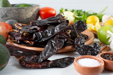 A view of a plate of chile New Mexico among other salsa ingredients.