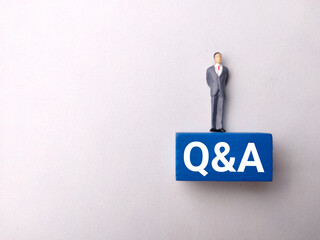 Top view miniature people with text Q AND A on white background