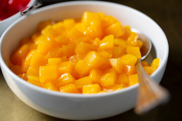 A view of bowl of canned peaches.