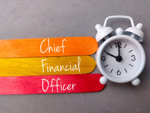 Top View Colored Ice Cream Stick And Clock With Text Chief Financial Officer On Gray Background