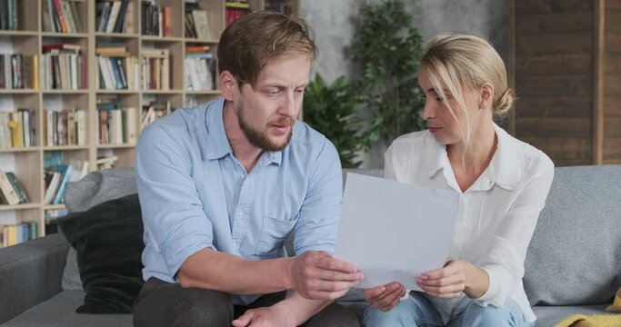 Husband and wife discussing medical analysis checking health consulting with doctor paperwork at home office. Family man woman talking together holding paper documents planning pregnancy parenthood