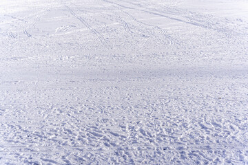 Many footsteps and lines in the snow, large snow area texture, winter in High Tatras Slovakia