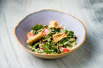 salad with fried eggplant in sweet sour sauce with tomatoes on grey table