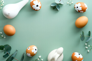 Happy Easter card design. Elegant painted Easter eggs with decorations on pastel green background....