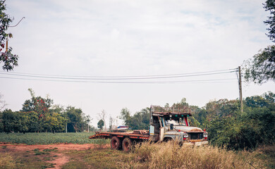 Fototapeta premium Old antique trucks are in rotten condition. Dirty and rusted, parked in the meadow