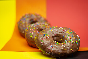 Chocolate donut with colored backgrounds