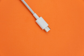 USB cable type C over orange background - obrazy, fototapety, plakaty