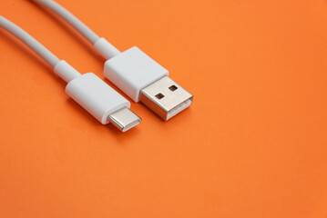 USB cable type C over orange background