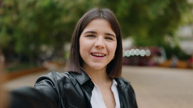 Young hispanic woman smiling confident having video call at park
