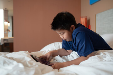 kid watching tablet, boy addicted cartoon