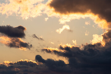 Dramatic sunset sky of clouds covering yellow sky.