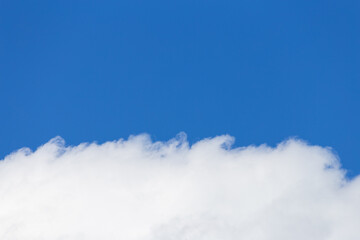 Fluffy white cloud with background of clear blue sky.