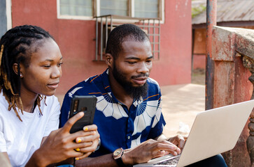 cropped image of two black male and female student using laptop