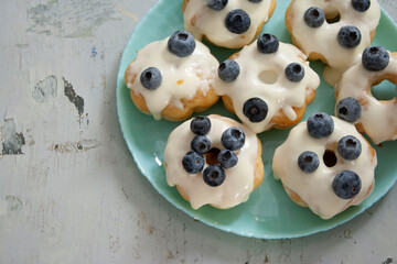 Blueberry cupcakes white cream blue plate grey background top view