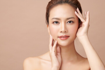 Beautiful young asian woman with clean fresh skin on beige background, Face care, Facial treatment,...