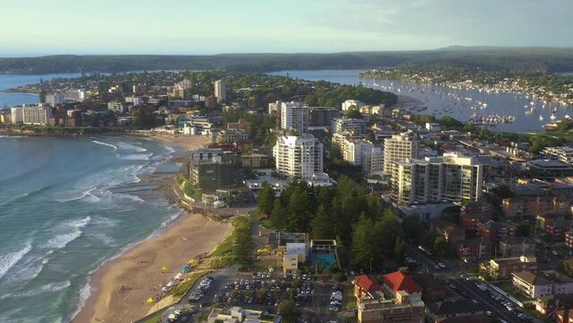 Aerial drone flyover of Cronulla in the Sutherland Shire, South Sydney, traveling south toward Port Hacking during summer in the early morning  