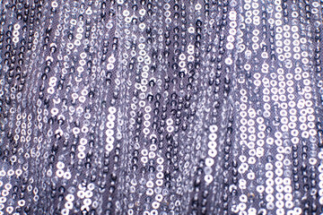 Pieces of cloth with silver sequins. Glitter background. Sequin texture
