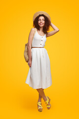 Charming woman in summer outfit in studio