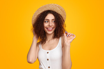 Charming woman in straw hat in studio